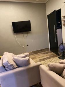 ein Wohnzimmer mit Couch und Flachbildfernseher in der Unterkunft Casa em Caraguatatuba 2 in Caraguatatuba