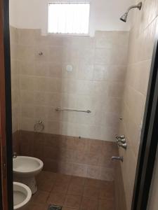 a bathroom with a toilet and a sink at El Bosque in San Marcos Sierras +2 photos