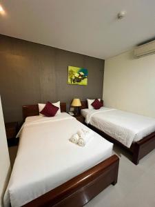Postelja oz. postelje v sobi nastanitve Doha Central Bliss Danang Hotel by Haviland