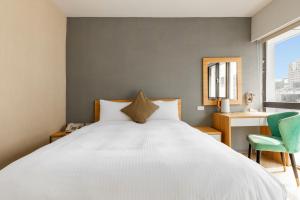 Postel nebo postele na pokoji v ubytování Mu Chen Hotel