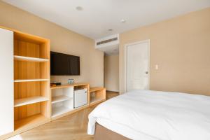 Postel nebo postele na pokoji v ubytování Mu Chen Hotel