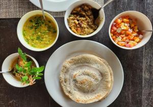 a table topped with plates of food and bowls of soup at Salty Mango Resort in Kalpitiya +13 photos
