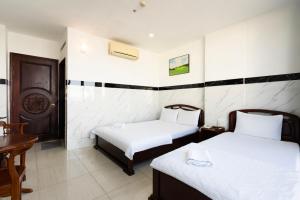 Postel nebo postele na pokoji v ubytování Lam Sơn Hotel 3 Tháng 2