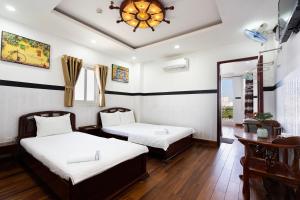 Postel nebo postele na pokoji v ubytování Lam Sơn Hotel 3 Tháng 2