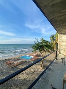 a view of the beach from the balcony of a house at Taipan Casa de Playa in El Puertón +6 photos