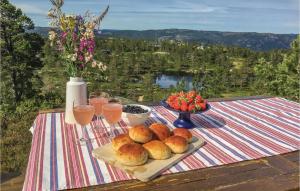 a table with a tray of bread and glasses of wine at Holiday Home Dølemo Hillestadheia Iii in Øvre Ramse