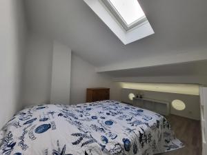 a bedroom with a bed with a blue and white blanket at Maison rénovée près de la mer avec 2 piscines, parking et animaux acceptés - FR-1-364-174 in Saint-Michel-Chef-Chef +22 photos