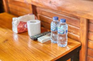 two bottles of water and a remote control on a table at DNR Lumbung Garden in Nusa Penida +21 photos