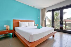 a bedroom with a large bed and a large window at Mana Mui Ne Beach Resort & Spa in Mui Ne +54 photos