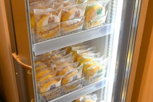 an open refrigerator filled with lots of food at 乃宿-noyado-長崎 in Nagasaki