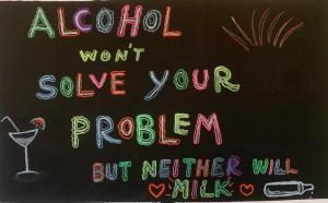 a chalkboard with the words alcohol wont solve your problem at The Black Sheep Hostel in Haad Rin