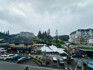 a city with cars parked in a parking lot at Ar Rayyan Hotel in Tanah Rata