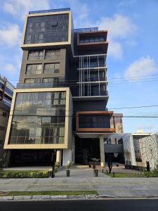a tall building with a lot of windows at Lindo Studio no Coração de Tambaú in João Pessoa
