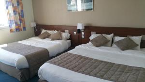 Postel nebo postele na pokoji v ubytování Hotel De La Mer