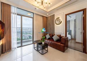 a living room with a couch and a large window at the Vinhome Central apartment - The Best Landmark Area in Ho Chi Minh City