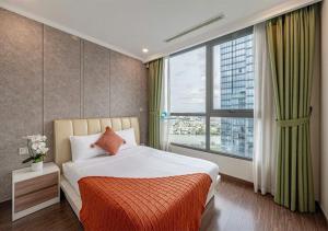 a bedroom with a bed and a large window at the Vinhome Central apartment - The Best Landmark Area in Ho Chi Minh City