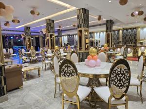 a restaurant with a table and chairs in a room at Rosewood Grand in Faridabad