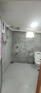 a bathroom with a toilet and a shower in it at Ayuvilla in Goiyapana