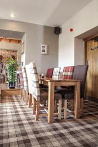 a dining room table and chairs in a room at Crofters Lodge in Barrow in Furness
