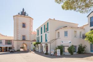 a street in a town with white buildings at Residence Port Bourgenay - maeva Home in Talmont