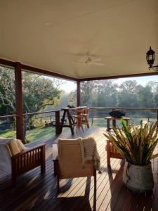 a screened in porch with a view of the water at Kenilworth Belli Creek Homestead Retreat in Gheerulla