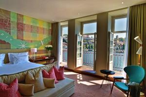 a hotel room with a bed and large windows at Pestana Vintage Porto Hotel & World Heritage Site in Porto