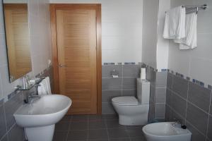 a bathroom with a toilet and a sink and a mirror at Hostal El Trovador in Altea