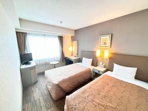 Postel nebo postele na pokoji v ubytování Grand Central Hotel