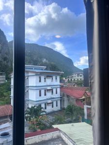 a view from a window of a city with mountains at Pantropiko Lodge in El Nido