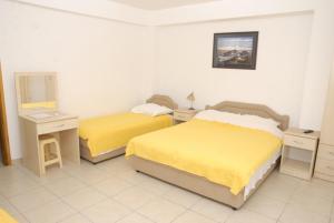 a hotel room with two beds and a mirror at Apartments Dosljak in Tivat