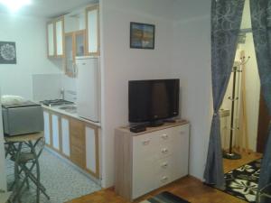 a kitchen with a tv on top of a dresser at Apartment Karlos in Zagreb