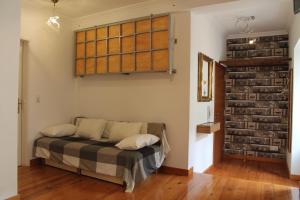 Cama en habitación con pared de ladrillo en Casa d Sintra, en Sintra