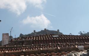 a roof of a building with a castle in the background at Casa d Sintra in Sintra