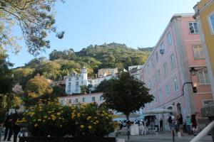 a city street with buildings and a hill in the background at Casa d Sintra in Sintra