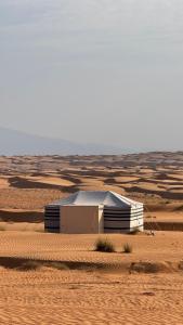 a small building in the middle of a desert at FYAFY Bidiyah Bedouin Camp in Bidiyah