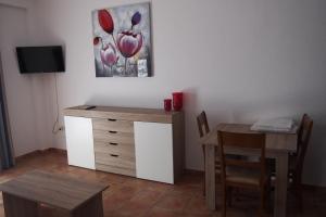 a room with a desk and a table and a painting at Hostal El Trovador in Altea