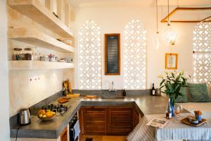 a kitchen with a sink and a counter top at Mawimbi Cottage in Ukunda