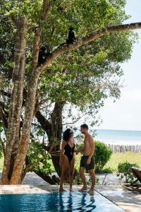 a man and a woman standing in a swimming pool at Mawimbi Cottage in Ukunda +3 photos