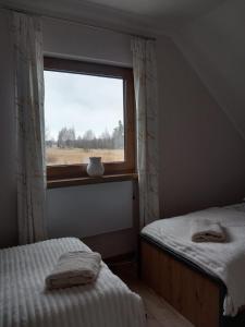 Postel nebo postele na pokoji v ubytování Domek Pod Lasem