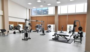 a gym with several treadmills and machines in a room at Arena Hotel Neftchala in Neftçala