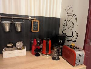 a kitchen counter with a red appliance on top of it at Chez les Martin in Castelnau-de-Médoc