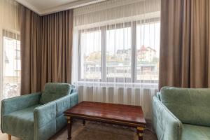 a room with two chairs and a table and a window at MARION SPA Hotel in Bukovel