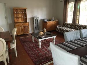 a living room with a couch and a table at The Garden Shed Guest House in Wellington