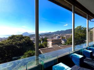 a view of the city from the balcony of a house at Yukemuri no sato azumaya in Beppu