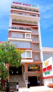 a tall building with stairs in front of it at Nam Kieu Hotel Ca Mau in Cà Mau