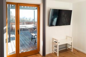Televízia a/alebo spoločenská miestnosť v ubytovaní Ferienhaus Sonnsitzer
