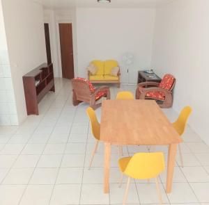 a living room with a wooden table and chairs at Town house beach 1 in Fare
