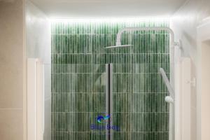 y baño con ducha con cortina verde. en At The Plaza Central Beach Flat, en La Herradura 33 fotos más