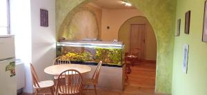 an aquarium in a room with a table and chairs at Penzion Avalon in Valtice