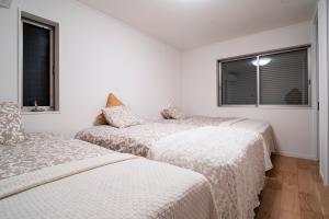 Llit o llits en una habitació de 全新三之轮一户建b栋